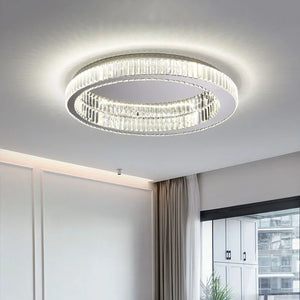 The Luxury Ceiling Circle Crystal Light, with its modern circular design, elegantly brightens a room decorated with light-colored walls and curtains.