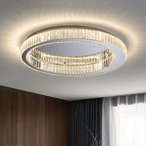 The Luxury Ceiling Circle Crystal Light, featuring crystal accents, illuminates a room with wooden walls and sheer curtains, providing multiple color temperatures to create the perfect ambiance.