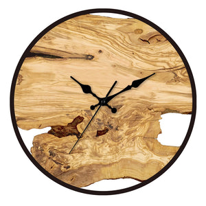 The Wood Circle Wall Clock boasts a natural wood grain face with black hands, elegantly highlighting a mix of light and dark wood tones, complemented by stylish Roman numerals in its rustic design.