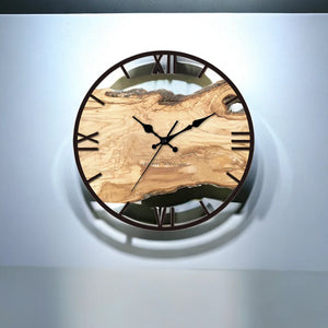 The Wood Circle Wall Clock showcases a rustic design with a wooden face and rich wood grain, embellished with Roman numerals on a durable metal frame. Its black hour and minute hands glide smoothly, making it the perfect Roman Numerals clock for any space.