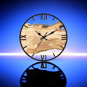 A large Wood Circle Wall Clock featuring Roman numerals and a textured wood face is set against a blue background, elegantly reflecting on a glossy surface.