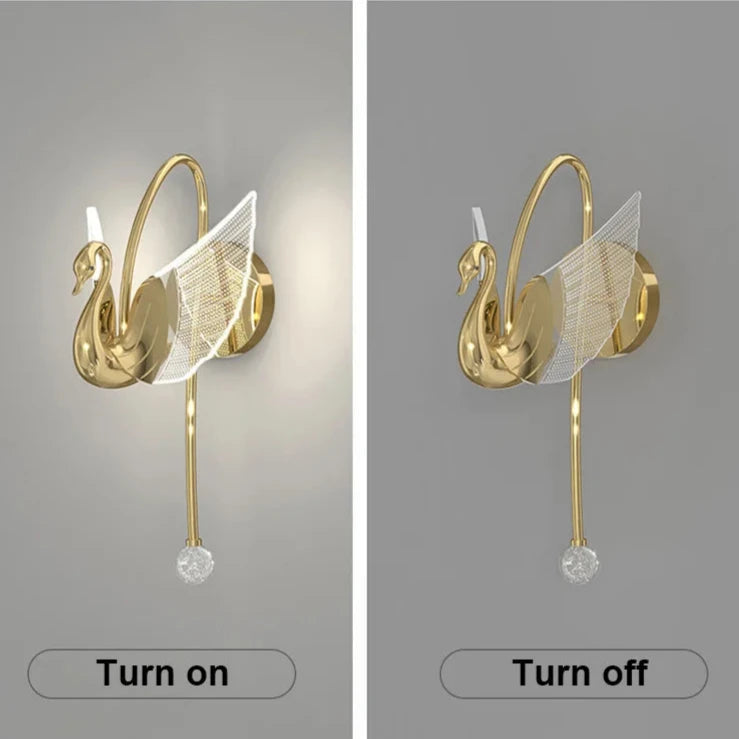 Side-by-side images of the Swan Wall Light reveal its stunning design. The image on the left displays the lamp illuminated, while the one on the right shows it in its off state. This elegant indoor lighting fixture boasts a golden finish and a crystal decorative element, making it a breathtaking addition to any room's decor.
