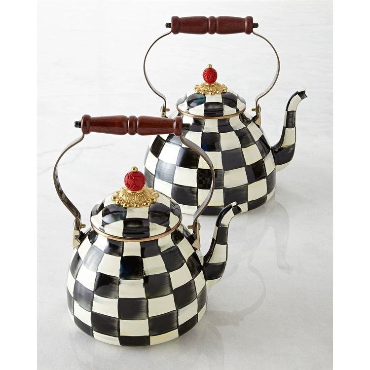 Two Vintage Black and White Kettles with checkered patterns, curved spouts, wooden handles, and red knobs on their lids are displayed on a white surface.