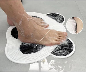 Feet are being pampered on a Panda Shower Massage Mat as soap bubbles froth on the tiled floor, enhancing relaxation and circulation.