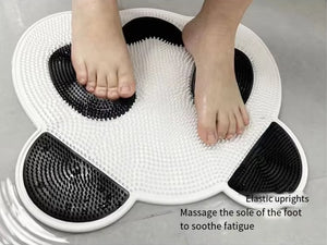 Feet on a textured panda-design mat. Text reads: "Elastic uprights massage the foot’s sole to soothe fatigue and boost circulation. Relax with the Panda Shower Massage Mat.