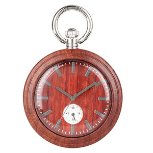 The Wood Pocket Watch is round and made of solid wood, featuring silver accents and a small seconds dial at the bottom center. The time displayed is about 1:55:20.