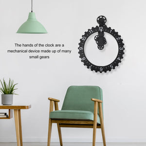 A modern interior features a Ring Gear Wall Clock, with its visible gears, beside a green chair and plant. Overhead, a pendant light casts its glow, while wall text explores the clock's intricate mechanics and gear dynamics.