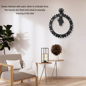 The Ring Gear Wall Clock, featuring stationary hands and a moving dial, adds an intriguing touch to the modern interior when mounted on the wall above a small table adorned with a plant and lamp. It's perfectly nestled next to an armchair and another potted plant.