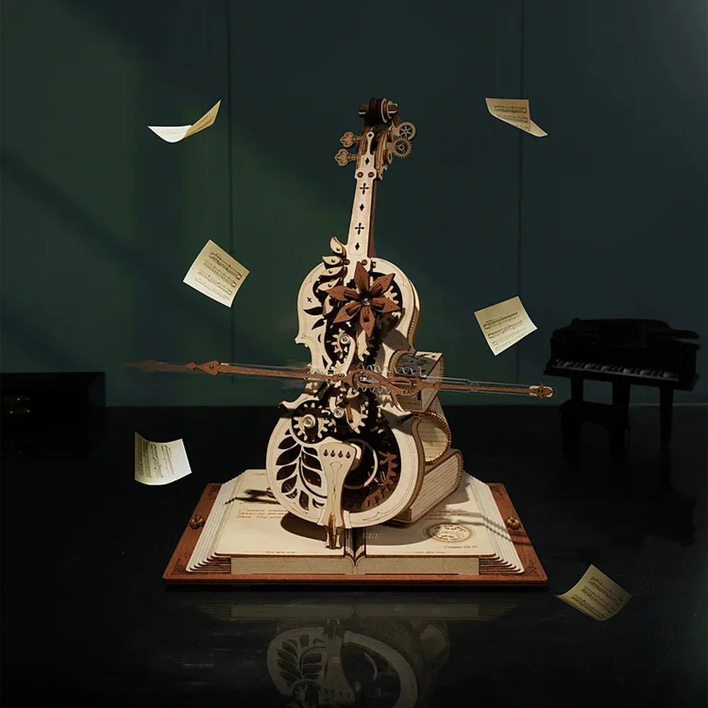The Cello Puzzle Music Box is a captivating 3D wooden puzzle resembling a cello, complete with gears and intricate designs, elegantly positioned on an open book. Surrounding the sculpture, floating music sheets contribute to an enchanting scene, while a piano in the dimly lit background enhances the ambiance of this mechanical music box masterpiece.