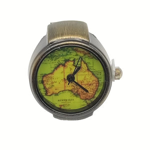 The Retro Aussie Ring Watch is a vintage-inspired timepiece with an Australian map on its face, black hour and minute hands, and a sleek metallic band.