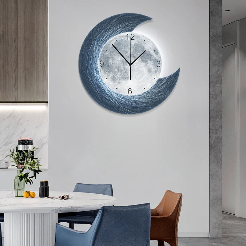The Concentric Orbit Minimalist Wall Clock, inspired by crescent and full moon shapes, hangs above a round dining table with four chairs in a stylish kitchen, offering statement lighting and artistic flair.