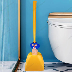 The Trump Tidy Toilet Brush is a novelty bathroom accessory with a handle styled as a figure in a blue suit and red tie, standing in a yellow holder next to a white toilet.
