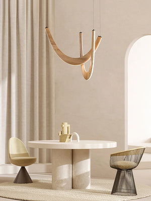 Minimalist dining area featuring a round table, two modern chairs in neutral tones, a textured rug, soft natural light, and the Double Curve Wood Pendant Light for added warmth and elegance.