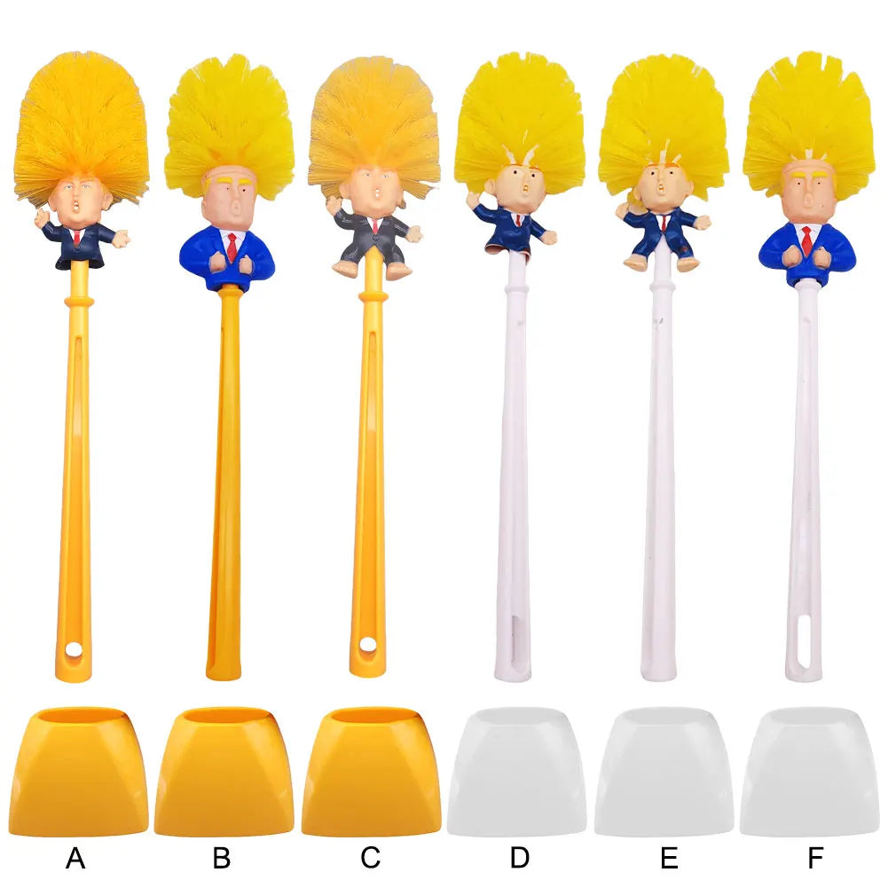 The Trump Tidy Toilet Brush features cartoon figure handles with yellow hair in blue suits, paired with matching holders labeled A to F (three yellow, three white). A humorous bathroom accessory for any fun-loving space.