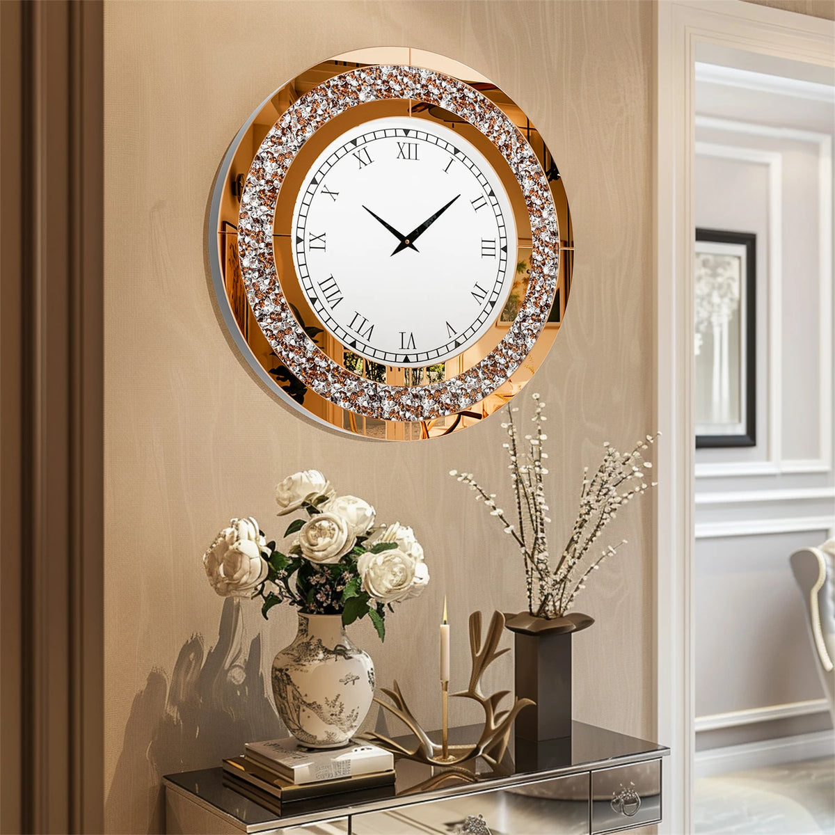 A Modern Luxury Roman Numerals Wall Clock hangs above a console table adorned with a vase of white flowers, books, and a candle, bringing timeless elegance to this chic home interior.