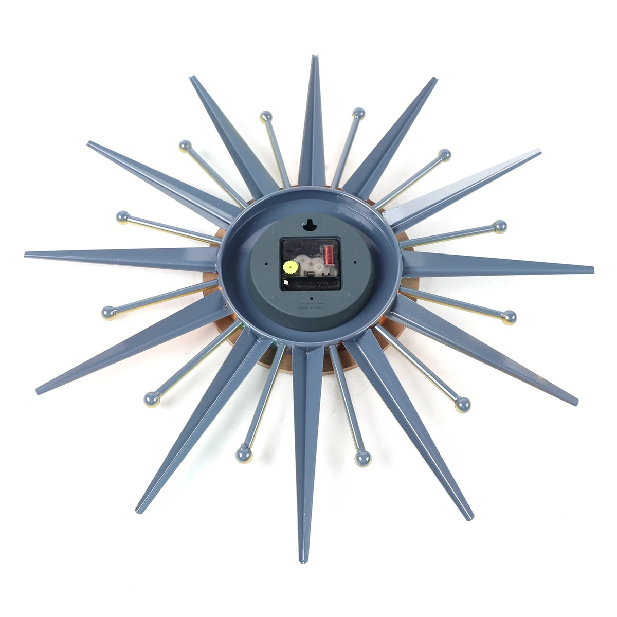 Back view of the Sunburst Wall Clock featuring its battery compartment, central mechanism, and blue-gray rays with gold accents radiating outward.
