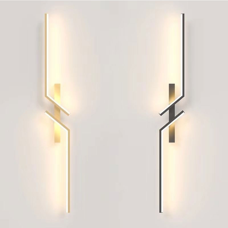 Two Minimalist Wall Sconce lights with geometric metal accents—one warm, one cool white—are mounted on a light-toned wall, providing decorative and stylish minimalist wall lighting.