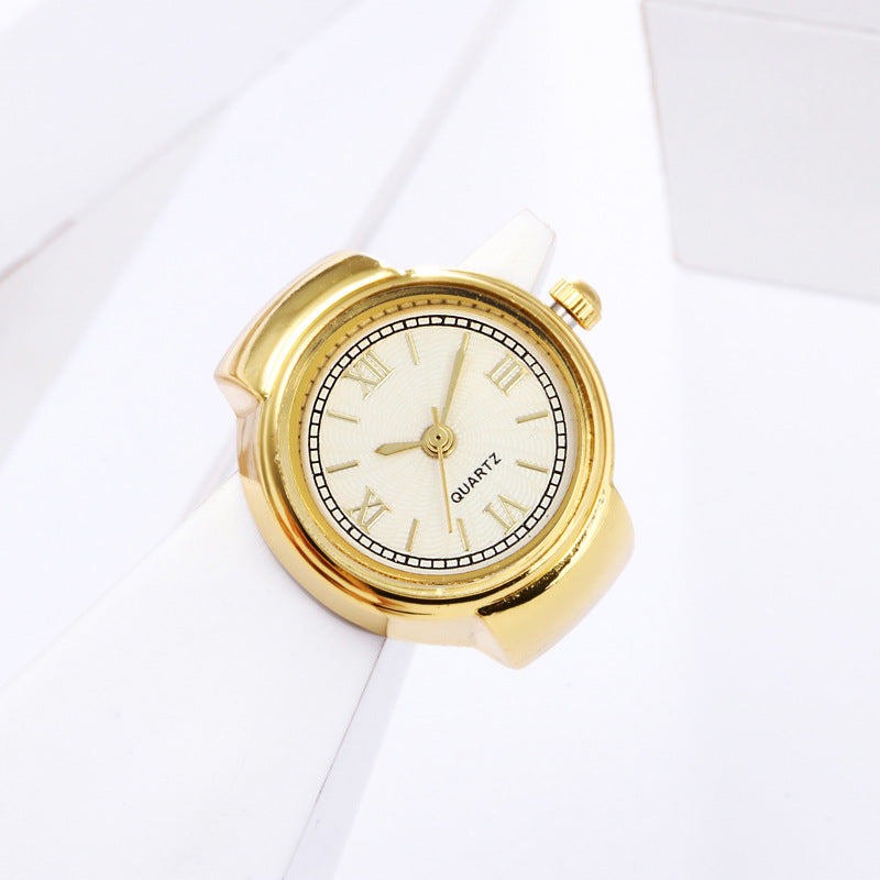 Eternal Ring Watch: A gold analog quartz wristwatch featuring a white face and Roman numerals, elegantly displayed on a white geometric surface—an ideal addition to any jewelry watches collection.