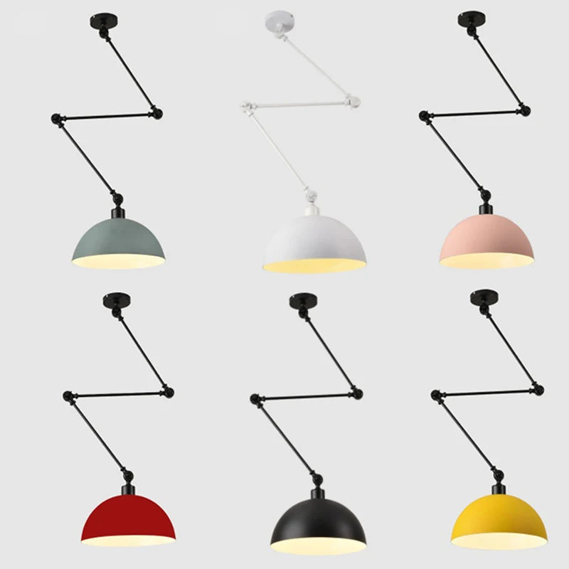 The Zig Zag Pendant Light features six adjustable pendant lamps in vibrant colors—green, white, pink, red, black, and yellow. Each lamp exhibits an industrial design with a dome-shaped shade and an adjustable arm system against a plain backdrop.
