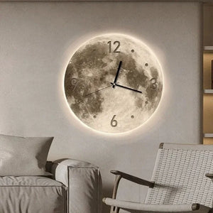 The Moon Wall Clock, with its realistic lunar surface texture and black hands, is perfect for adding celestial charm above a beige sofa and next to a woven chair in any cozy corner.