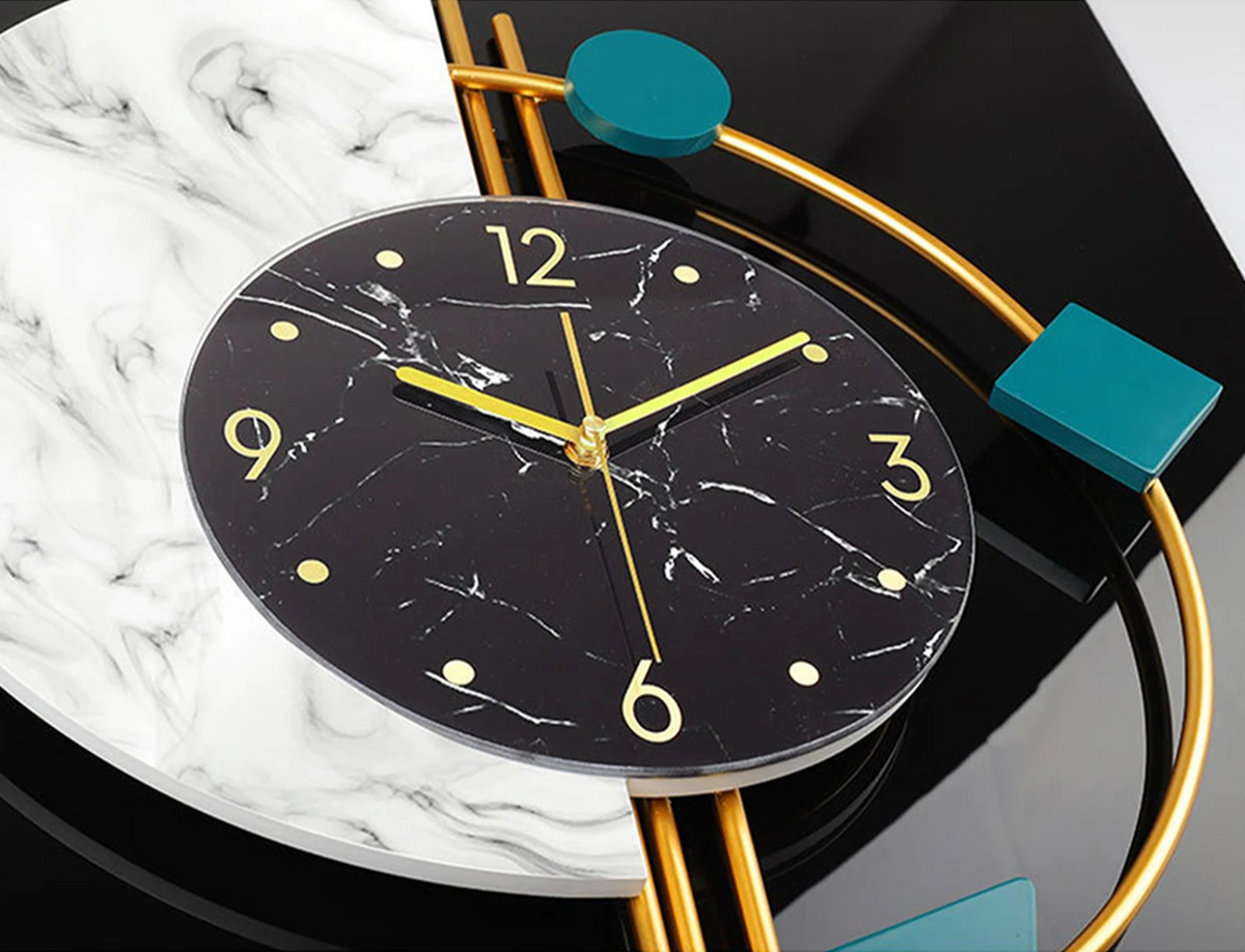 Close-up of the Modernist Constellation Accent Clock featuring a black marble-patterned face, gold hands, minimalist markers, and abstract gold and teal geometric accents—a striking statement piece for any space.