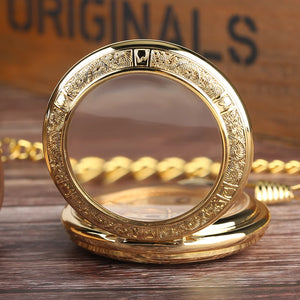 The Premium Golden Pocket Watch, featuring an ornate engraved border and clear front cover, is shown open on a wooden surface with its elegant gold chain partially visible.