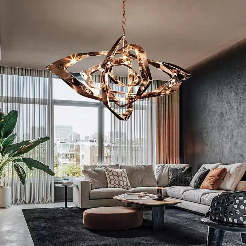 Modern living room with large windows, a gray sectional sofa, assorted cushions, indoor plants, and the Elegant Industrial Gallery Pendant in rose gold hanging from the ceiling.
