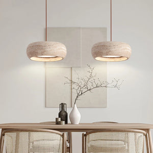 Minimalist dining area with two Natural Stone Pendant Lights, a table set with vases, and neutral-toned wall art in the background.