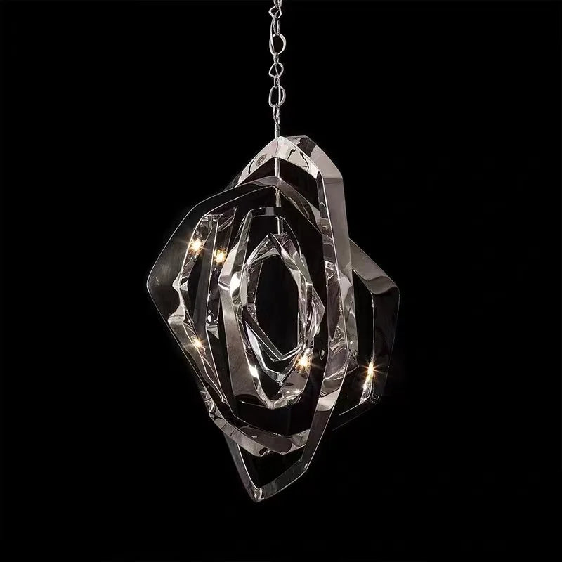 The Elegant Industrial Gallery Pendant is a modern LED light with sculptural overlapping rose gold rings and embedded LEDs, suspended by a chain against a black background.