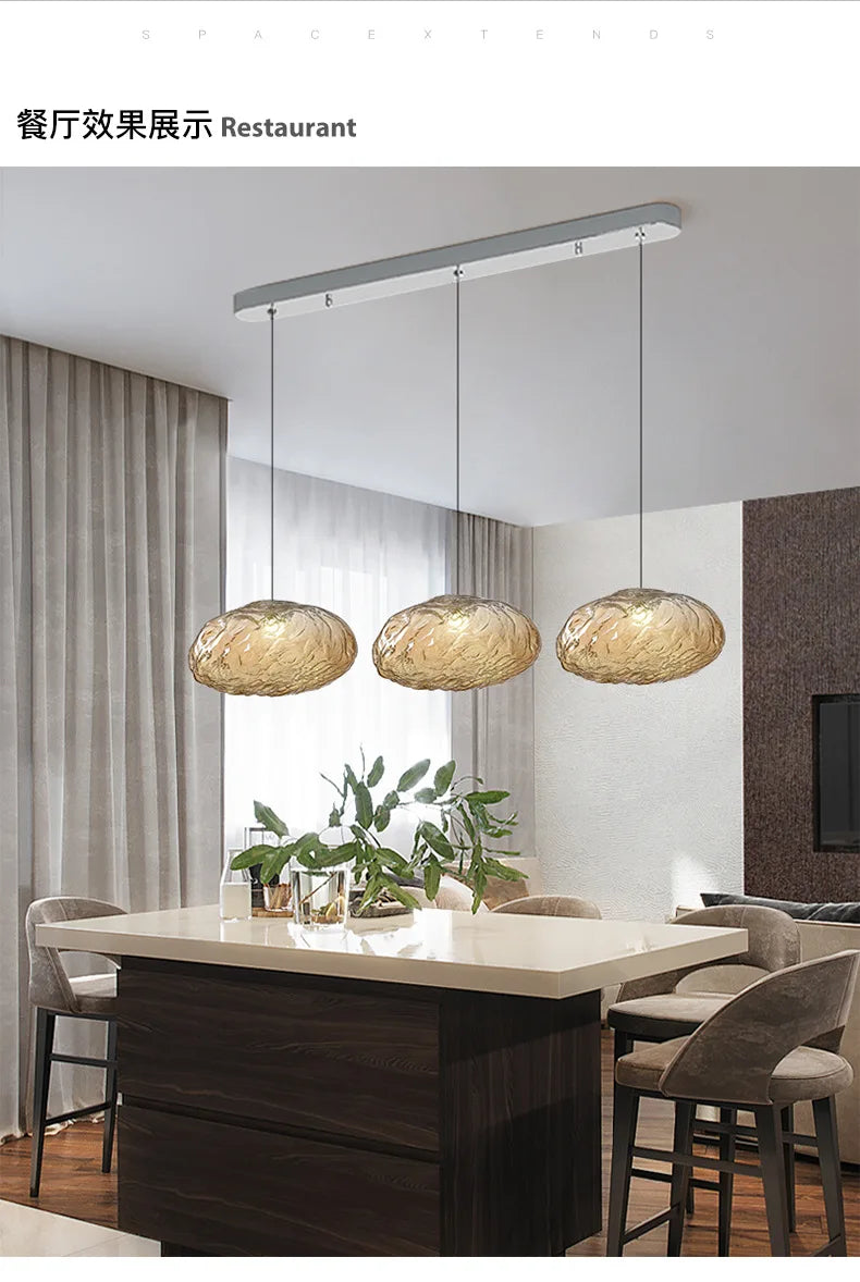 Modern dining area featuring the Luxe Cloud Glass Pendant Light above a rectangular table, surrounded by cushioned chairs and highlighted with a plant centerpiece.