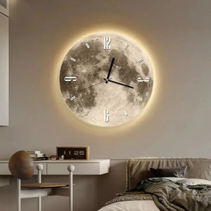 A Moon Wall Clock with a lunar surface texture and glowing edges is mounted above the bed, enhancing the ambiance. To the left, there is a desk with a chair and small decorative items.