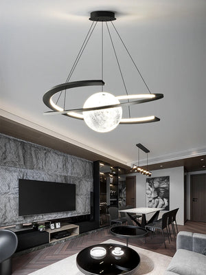 Modern living room with a Moon Trajectory Pendant Light resembling the moon's path. The space houses a TV, abstract wall art, a dining table, and contemporary decor in neutral tones enhanced by efficient LED technology.