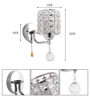 The Luxury Cylinder Wall Light features a crystal-covered shade, stands 22cm tall, has a 12cm diameter shade and 10cm wall mount, plus a pull switch and sparkling crystal ornament for luxurious lighting.