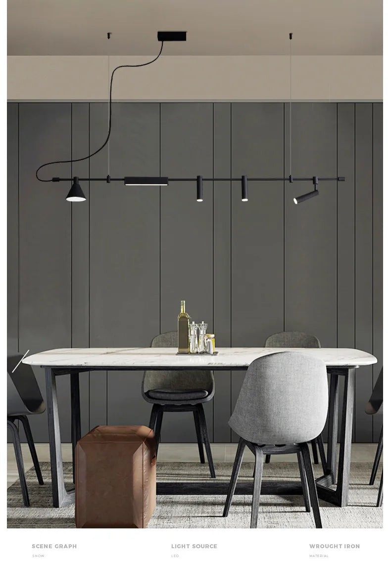 A modern dining room with an industrial marble table, six gray chairs, a brown ottoman, and a black Modern Track Lighting fixture against a gray paneled wall.