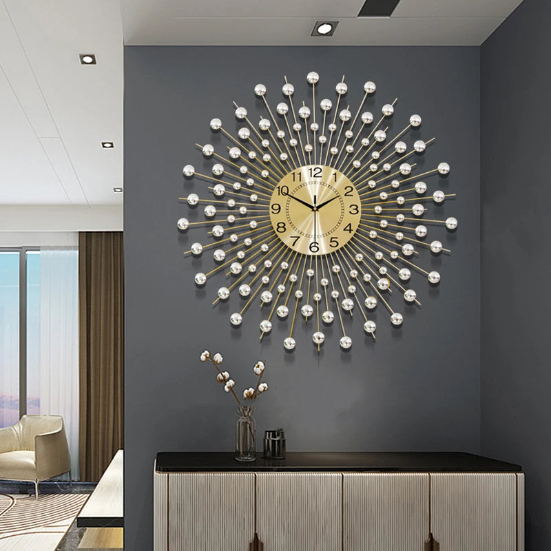 The Lux Radiance Starburst Wall Clock, featuring gold metallic spokes and silver spheres, hangs above a modern white cabinet in a contemporary living room, creating a striking focal point.