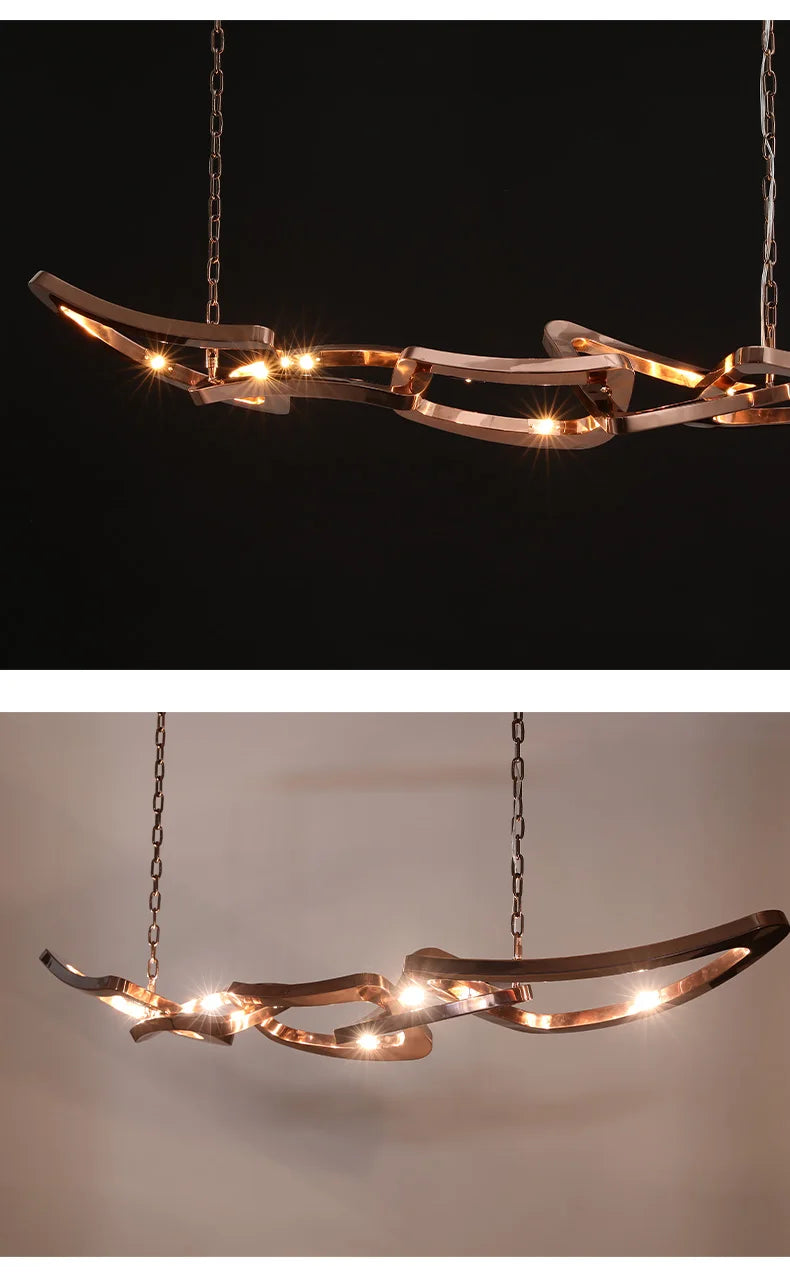 The Elegant Industrial Gallery Pendant is a modern metal chandelier with built-in LED lights, suspended by two chains and shown illuminated against black and white backgrounds.