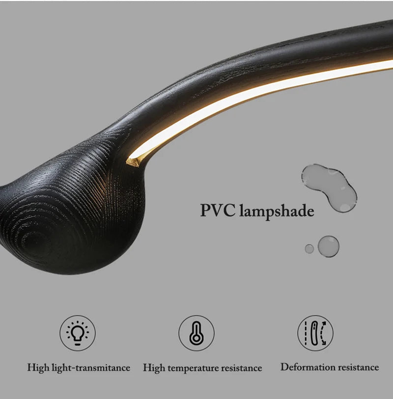 Close-up of the Tideform Biomorphic Pendant Light—a black, curved PVC lamp with integrated LED strip. Showcasing Nordic minimalism, it offers high light-transmittance plus resistance to heat and deformation.