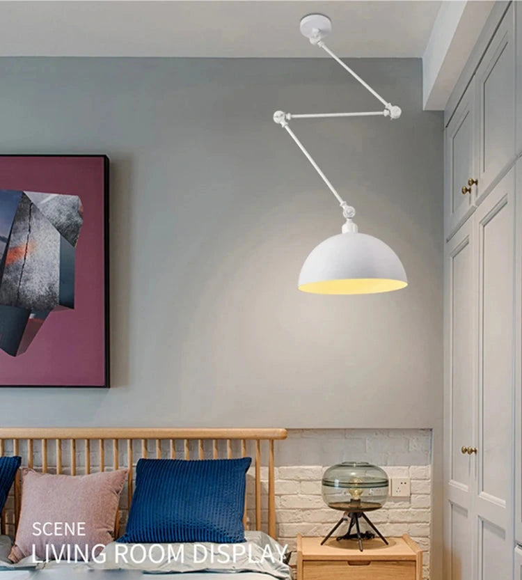 A modern living room features a Zig Zag Pendant Light with an industrial design, a wooden sofa with blue and beige cushions, abstract wall art, and a black side table holding a transparent lamp next to a brown object.