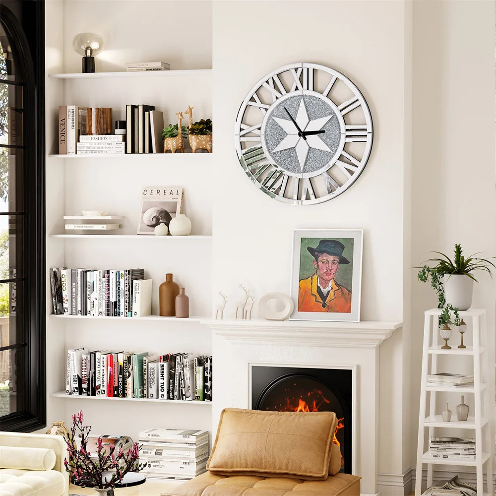 A living room features white shelves, books, decorative items, a fireplace topped with a framed portrait, and the Astral Chic Roman Wall Clock on the wall. A tan chair and lush plants add warmth to this stylish space.