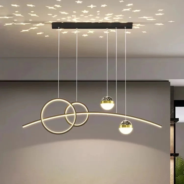 The Stellar Pendant Light boasts three illuminated spheres and two intersecting rings, casting star-shaped patterns on the ceiling. Its celestial accents enhance geometric illumination, creating a captivating ambiance in any room.