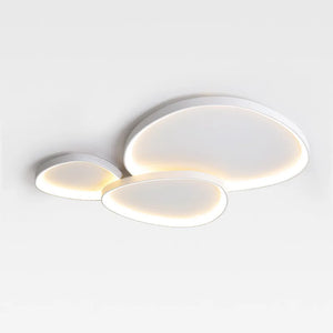 The Nordic Minimalist Ceiling Light is a modern fixture with three overlapping ovals, offering dimmable brightness and color temperature control for a soft glow.