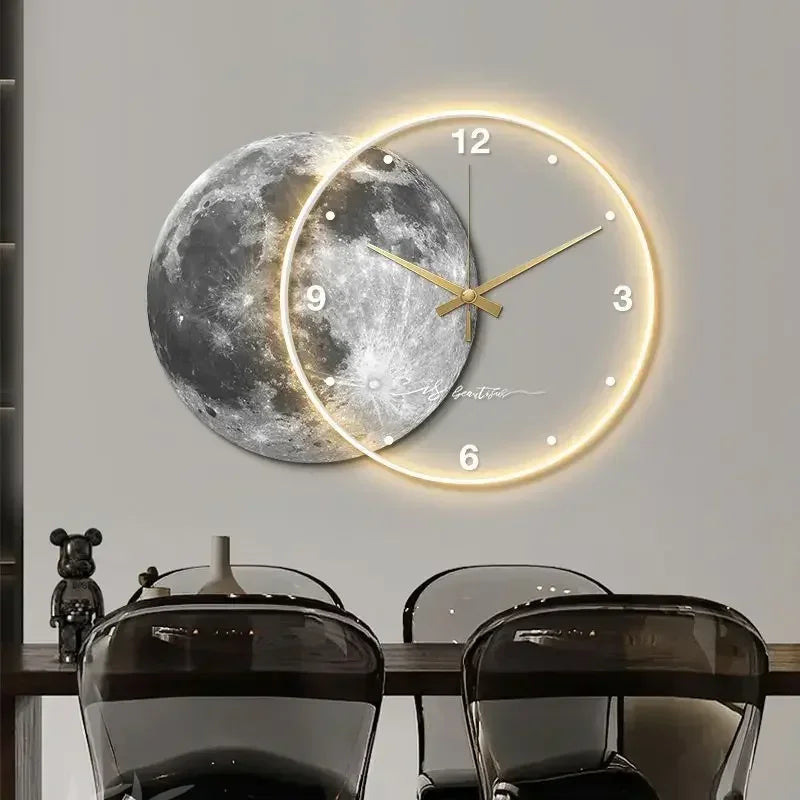 A modern Celestial Wall Clock Light with a glowing face overlaps a realistic moon image. Below, a table with clear chairs and decorative objects enhances the unique home decor.