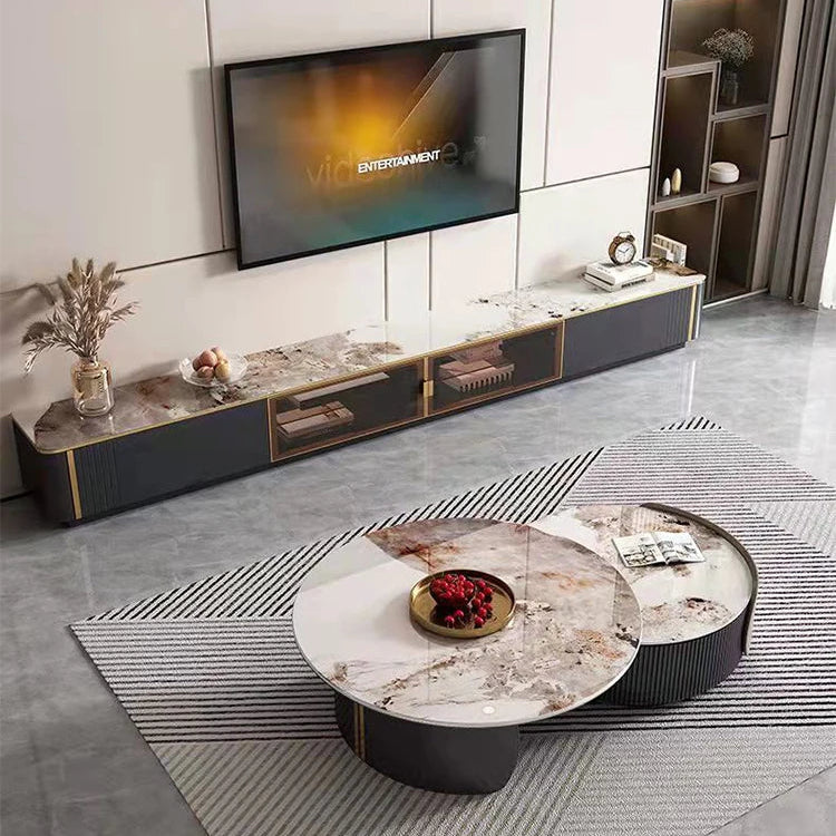 Modern living room with a wall-mounted TV, Luxe Round Coffee Table, long marble console, decorative items, and a striped rug on a gray floor.