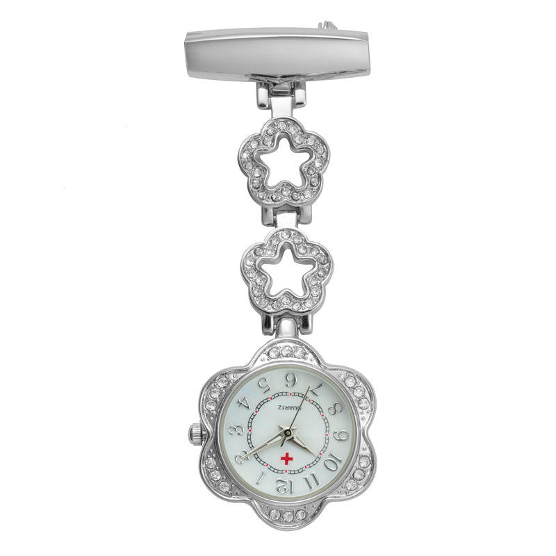 The Luxe Fob Pocket Watch features flower-shaped links, sparkling crystal accents, a white dial with Arabic numerals, and a red cross.