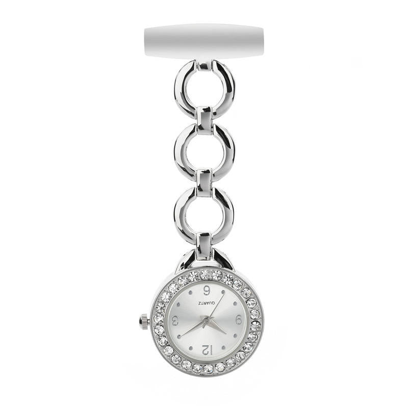 The Luxe Fob Pocket Watch features a white face, sparkling crystals set around the bezel, and comes with a silver chain link attached to a white pin.
