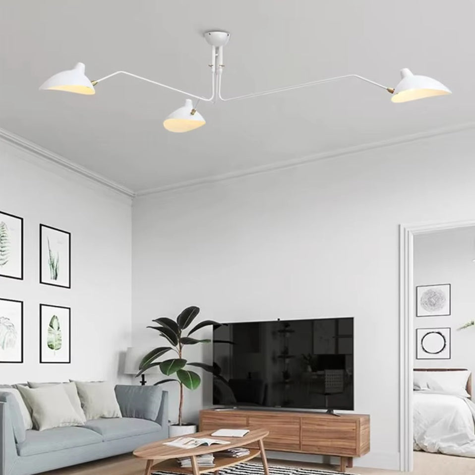 Modern living room with a Sleek Industrial Pendant Light, gray sofa, wooden coffee table, potted plant, and wall art. A TV rests on a wooden stand in front of the sofa.