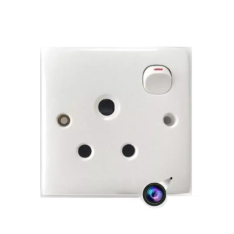 The Smart Electrical Outlet SpyCam is a white outlet with a discreet camera lens in the lower right corner for real-time recording.