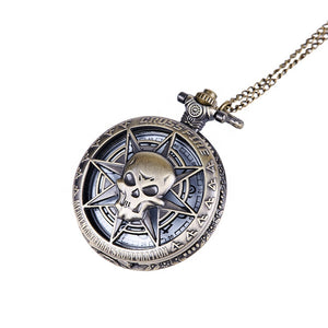 The Skeleton Pocket Watch features a skull and star cover design with "CROSSFIRE" embossed on the edge, complete with a chain—an engraved pocket watch showcasing striking antique style.