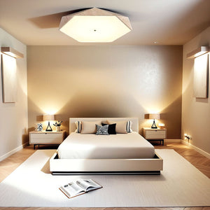 Modern bedroom with a low platform bed, two nightstands with lamps, a large Natural Stone Ceiling Light, neutral walls, and an open book on a white rug.
