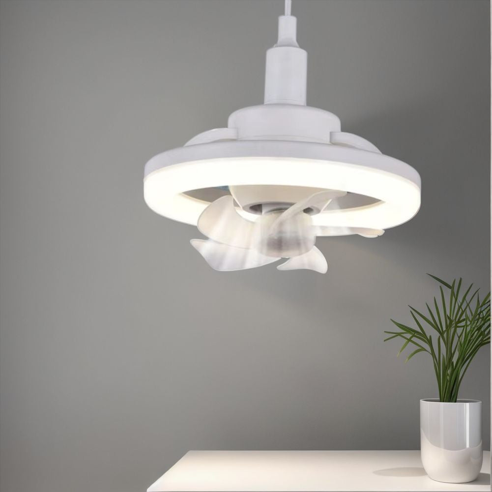 The 360° Rotatable Fan Light, mounted on a gray wall above a white table with a small plant, provides ambient lighting and optimal air circulation.